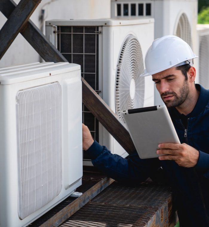 Engineers are inspecting the air conditioning cooling system of a large building or industrial facility.