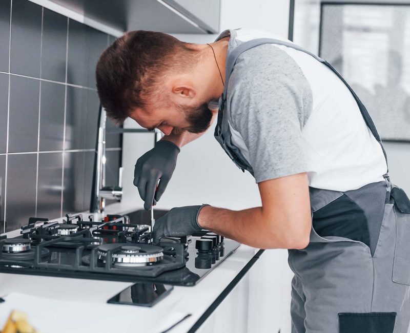 young-professional-plumber-in-grey-uniform-working-resize.jpg